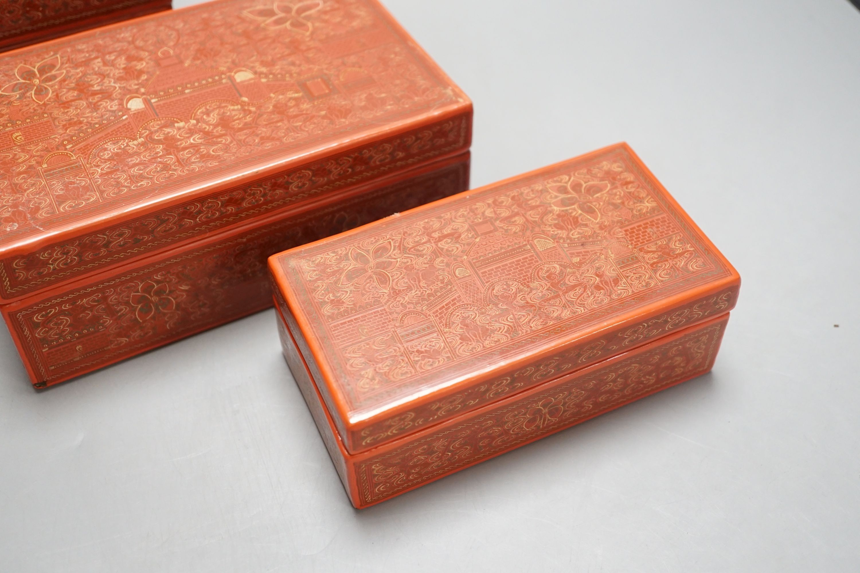 Three Burmese red lacquer graduated boxes, largest 21 cms wide.